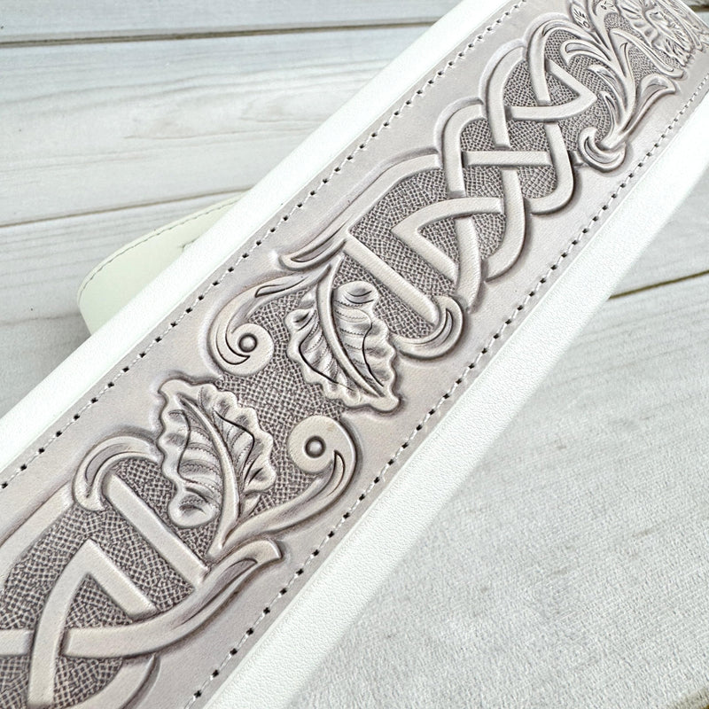 Walker And Williams KB-05-WHT Aged White Celtic Knot Full Grain Carving Leather Padded Strap With Arctic White garment leather Backing For Acoustic, Electric, And Bass Guitars